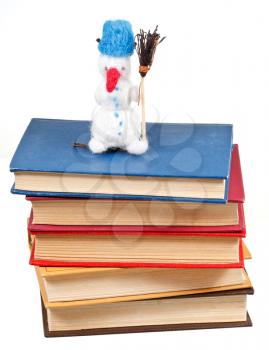 felt soft toy snowman on stack of books isolated on white background