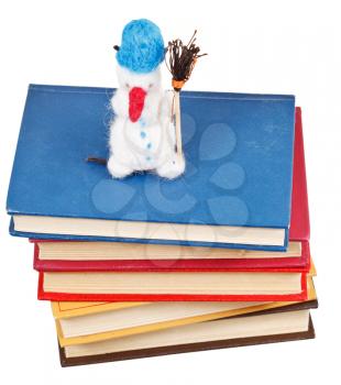 felt soft toy snowman on books isolated on white background