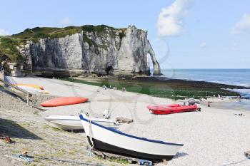 boats on resort english channel beach and view of cliff in Etretat town, Frace