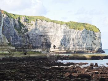 stone beach and cliff on english channel Etretat cote d'albatre, France