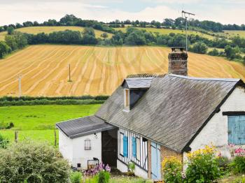 peasant farm and harvested field in Normandy, France