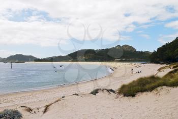people on sand beach of Cies Islands (illas cies) - Galicia National Park in Atlantic Ocean, Spain