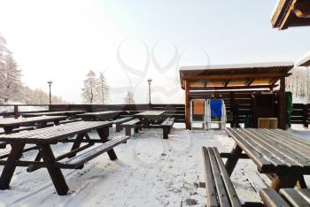 empty wooden tables in mountain restaurant in skiing area Via Lattea (Milky Way), Sestriere, Italy