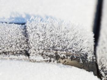 frozen ice crystals close up on car in autumn