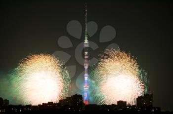 scene with fireworks and Ostankino TV Tower in Moscow in night