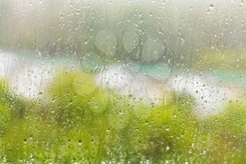 rain outside window - raindrops on windowpane in summer day