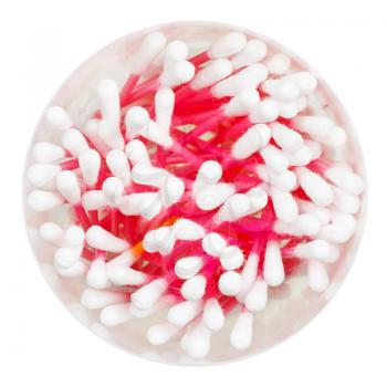 top view of many pink cotton swabs in round container isolated on white background