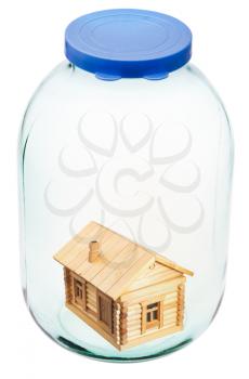 new wooden house in closed glass jar