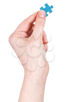 female hand holding jigsaw puzzle piece isolated on white background