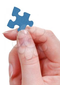female fingers holding jigsaw puzzle piece isolated on white background