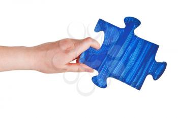 female hand with painted blue puzzle piece isolated on white background