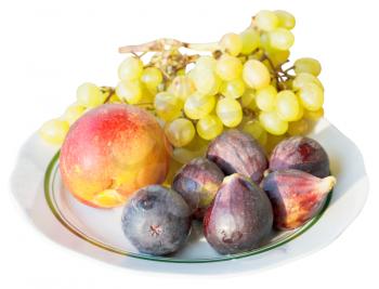 ripe seasonal fruits on plate isolated on white background
