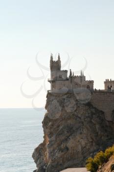 Aurora cliff with Swallow's Nest castle at sunrise on Southern Coast of Crimea