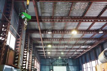 hoist with bridge crane and scales in hangar warehouse