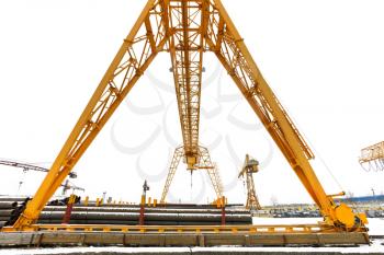 bridge crane over outdoor warehouse with metal products