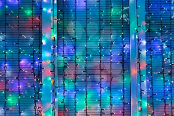 outdoor Christmas lights decorate window in night