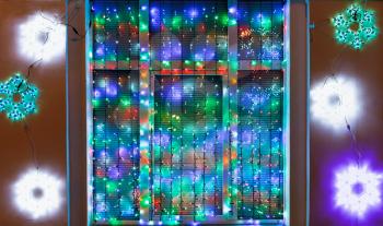 outdoor Xmas garland decorate window in night