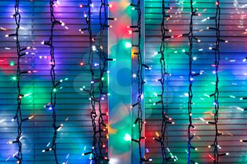 outdoor Christmas multi-color electric lamps decorate window in night