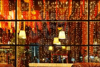 Christmas decorative lights of restaurant window in night