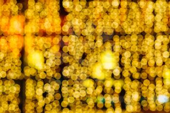yellow blurred lights of Xmas window decoration in night