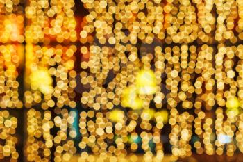 yellow blurred lights of christmas window decoration in night