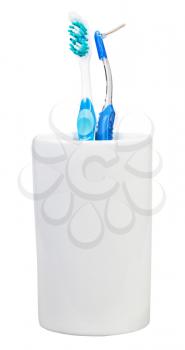 one toothbrush and interdental brush in ceramic glass isolated on white background