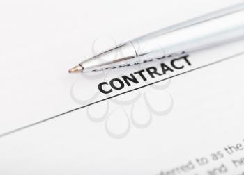 sales contract and silver pen close up