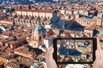 travel concept - tourist taking photo of maggiore square in Bologna on mobile gadget