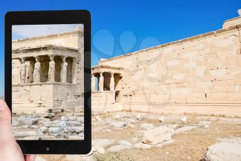 travel concept - tourist taking photo of erechtheion monument at acropolis on mobile gadget, Athens, Greece