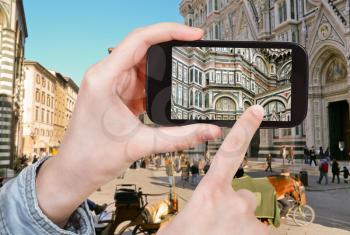 travel concept - tourist taking photo of The Basilica di Santa Maria del Fiore in Florence on mobile gadget, Italy