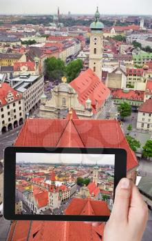 travel concept - tourist taking photo of Munich skyline on mobile gadget, Germany