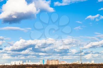 white clouds in blue spring sky over city, Moscow