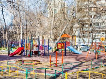 children's playground in city yard in spring