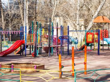 children playground in urban yard in spring