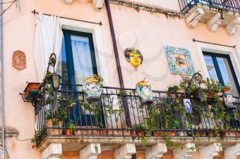 TAORMINA, ITALY - APRIL 3, 2015: decorated balcony of urban house in Taormina town, Sicily.