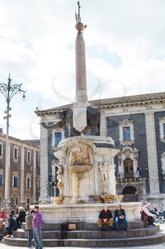 CATANIA, ITALY - APRIL 5, 2015: people on Piazza del Duomo and U Liotru (Fontana dell ' Elefante) near Town Hall, Sicily, Italy. The fountain was assembled in 1736 by Giovanni Battista Vaccarini.