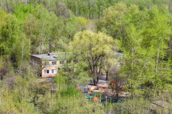 kindergarten in green woods in sunny spring day