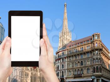 travel concept - tourist photograph towers of St Stephan Cathedral, Vienna, Austria on tablet pc with cut out screen with blank place for advertising logo