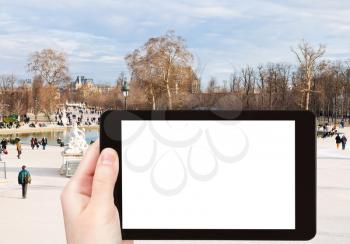 travel concept - tourist photograph Grand Basin Octagonal in Tuileries Garden, Paris, France on tablet pc with cut out screen with blank place for advertising logo