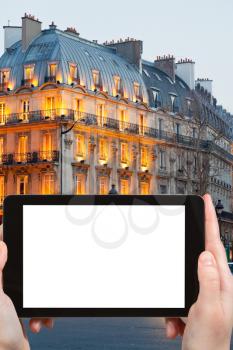 travel concept - tourist photograph house on boulevard Saint Michel in Latin Quarter in evening, Paris, France on tablet pc with cut out screen with blank place for advertising logo