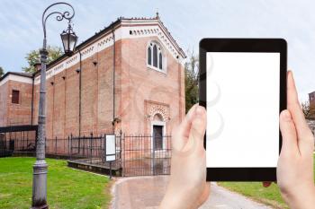 travel concept - tourist photograph Scrovegni Chapel in Padua, Italy in autumn day on tablet pc with cut out screen with blank place for advertising logo
