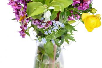 bunch of wild flowers in glass vase on white background