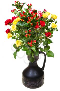 bouquet from yellow and red roses and hypericum flowers in ceramic jug on white background