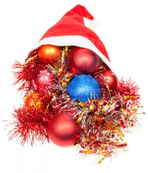 christmas giftsl - xmas balls and decorations fall out from red santa hat on white background