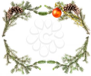 christmas greeting card frame - spruce tree branches with cones and orange ball on white background