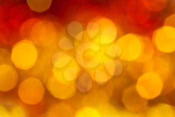 abstract blurred background - big yellow and red flickering Xmas lights of garlands on Christmas tree