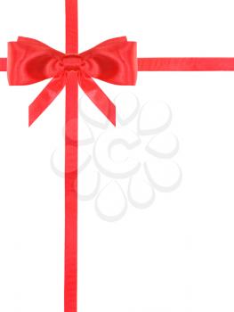 one red satin bow in upper left corner and two intersecting ribbons isolated on vertical white background