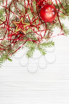 Christmas greeting card - border from star and red Xmas bauble and tree branch on blank paper background