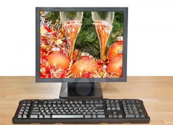 Christmas still life with orange baubles and glasses on desktop PC isolated on white background