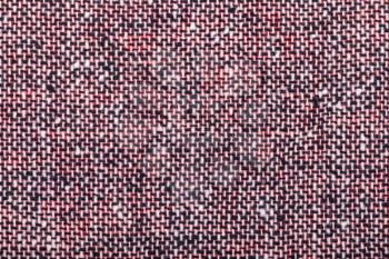 background from red black and white woolen neps fabric close up